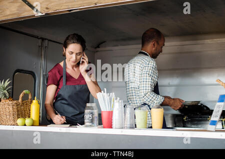Vendors working in food truck Stock Photo