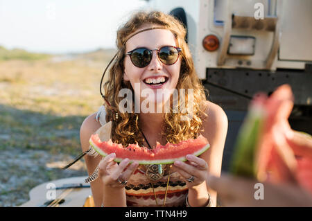 Happy woman eating watermelon at beach Stock Photo
