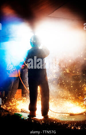 Workers welding airplane wing at industry Stock Photo