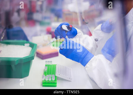 High angle view of scientist working in laboratory seen through window Stock Photo