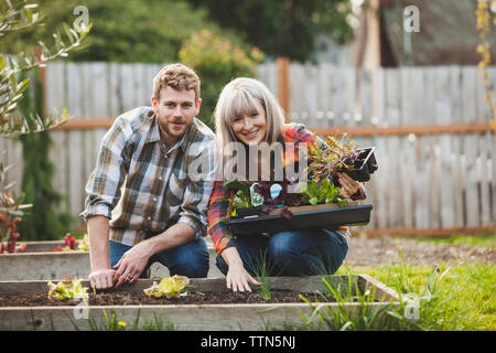 Portrait of couple gardening at backyard Stock Photo