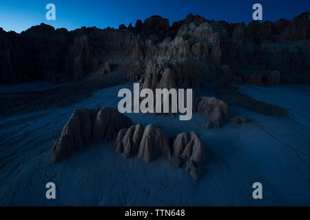 Cathedral Gorge State Park against clear sky at dusk Stock Photo