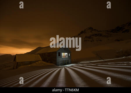 View of Independence Mine State Park against mountains during night Stock Photo