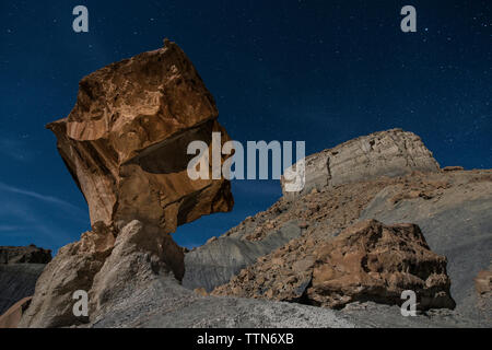 Low angle view of rock formations against star field at Grand Staircase-Escalante National Monument Stock Photo