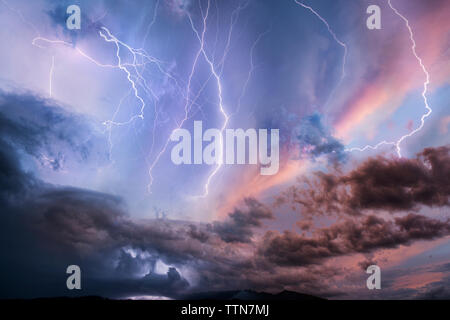 Low angle view of thunderstorm at dusk Stock Photo