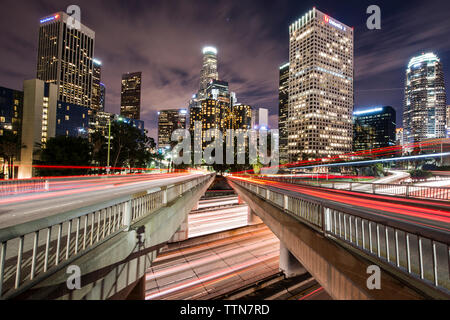 Light trails on bridges in city at night Stock Photo