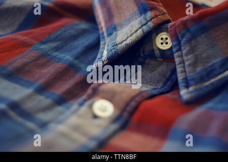Part of the shirt in red and blue checkered, where there is also a collar and white buttons Stock Photo