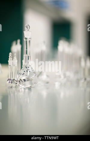 Laboratory glass chemical containers on glass table isolated colorful ...