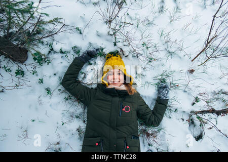girl lying in the snow Stock Photo