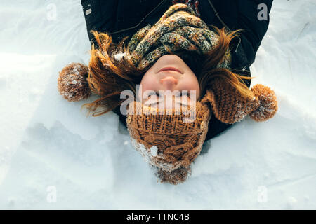 Woman lying in the snow Stock Photo