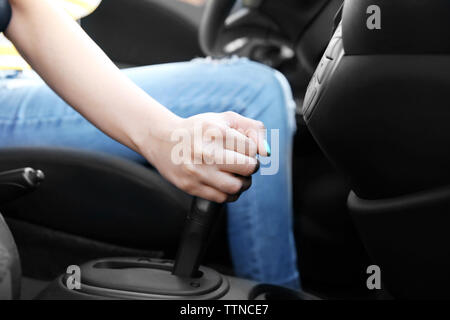 Female hand shifting gears in car Stock Photo