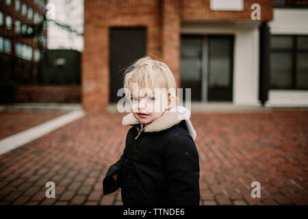 Blonde toddler in historic Fells Point Baltimore, in the winter Stock Photo