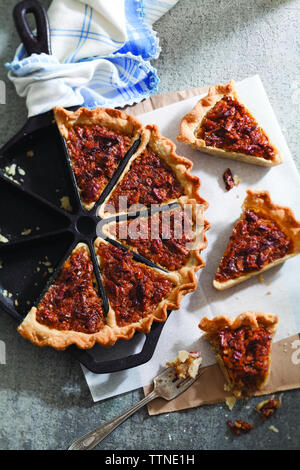 High angle view of coconut pecan pie served on table at home Stock Photo