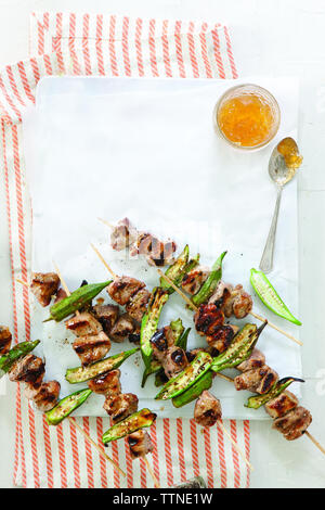 High angle view of grilled appetizers with sauce in tray on table at home Stock Photo