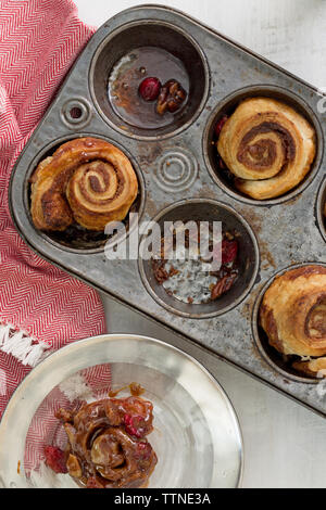 High angle view of cranberry sticky buns in baking tray with napkin on table Stock Photo