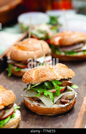 High angle view of burgers on wooden table in cafe Stock Photo