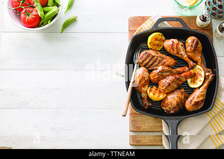 Overhead view of fresh grilled chicken meat in skillet on table at home Stock Photo