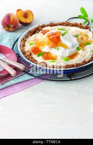 Close-up of food in plate by peaches on table at home Stock Photo
