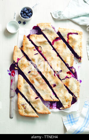 Overhead view of sliced blueberry pie on table at home Stock Photo
