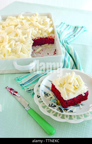 Slice of red velvet cake served in plate on table at home Stock Photo