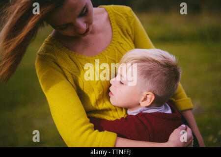 Son embracing mother on field Stock Photo