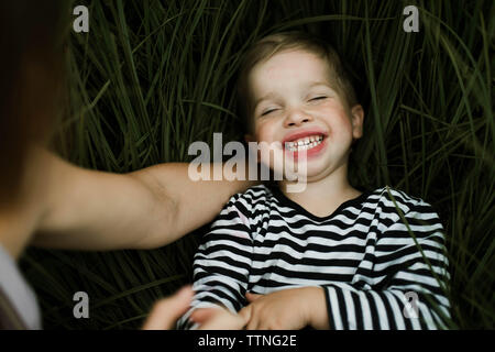 Little boy and his mother playing  on green meadow Stock Photo