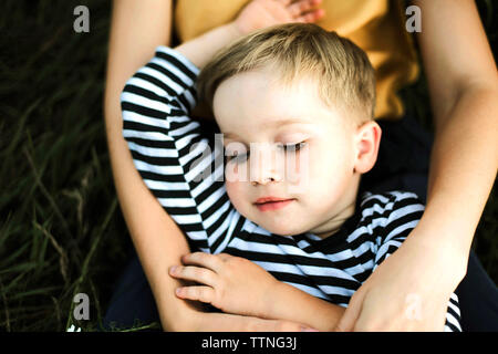 Portrait of a mother and boy lying outdoor. Stock Photo