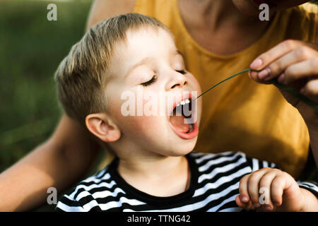 Portrait of a mother and boy sitting outdoor. Stock Photo