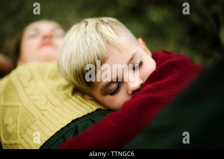 Son embracing mother on field in the countryside Stock Photo