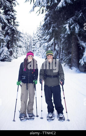 Portrait of couple wearing snowshoes Stock Photo