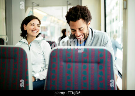 Happy multi-ethnic couple travelling in bus Stock Photo