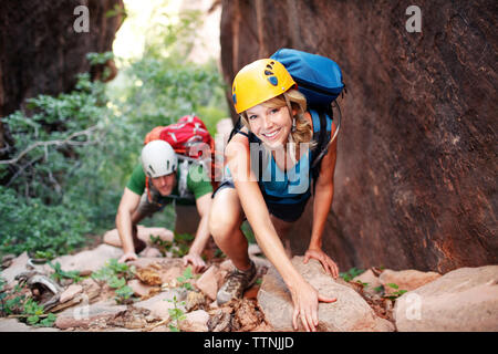 High angle view of male and female hikers climbing mountain Stock Photo