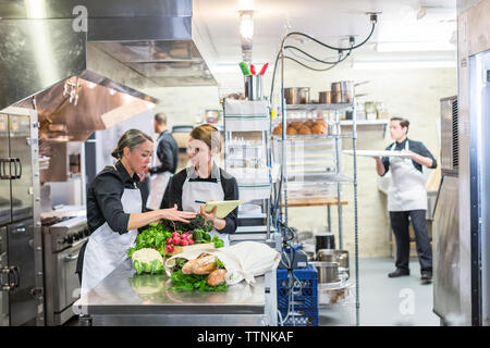 Chefs working in restaurant kitchen Stock Photo