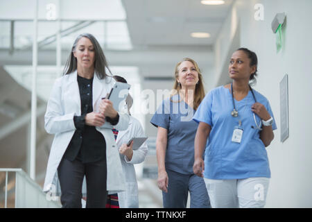 Female doctors walking in hospital corridor Stock Photo