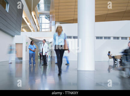 Healthcare workers talking in hospital corridor Stock Photo