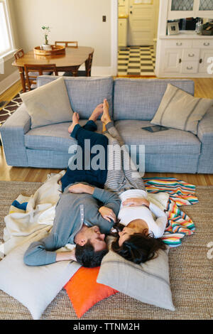 High angle view of couple relaxing on carpet at home Stock Photo