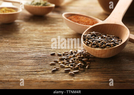 Healing seeds in spoons on wooden background Stock Photo