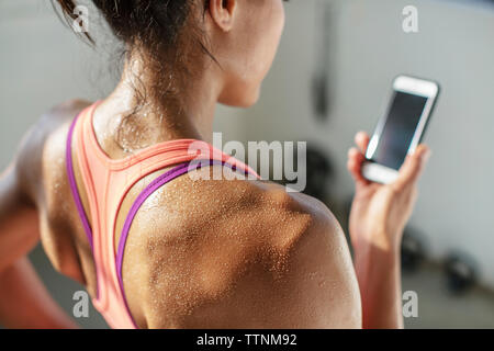 Close-up of female athlete using mobile phone in gym Stock Photo
