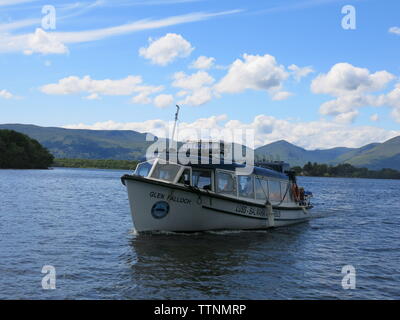 Picture postcard view of a sunny day on Loch Lomond with the Luss - Balmaha express boat, the Glen Falloch coming towards the pier at Balmaha. Stock Photo