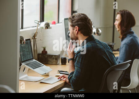 business people working on desktop computers at table in office Stock Photo