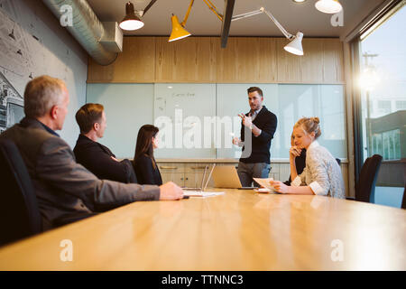 businessman giving presentation to colleagues in board room Stock Photo