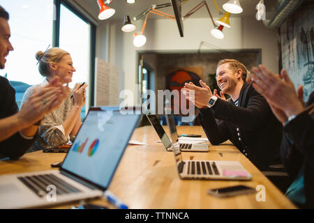 business people applauding in meeting at board room Stock Photo