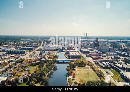 Aerial view of cityscape against sky during sunny day Stock Photo