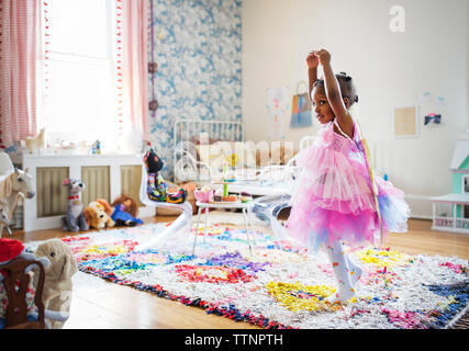 Full length of girl in fairy costume dancing at home Stock Photo