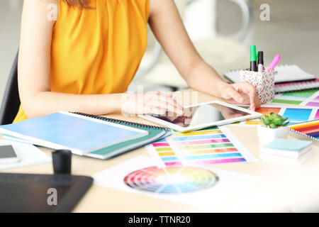Designer workplace. Woman using tablet Stock Photo