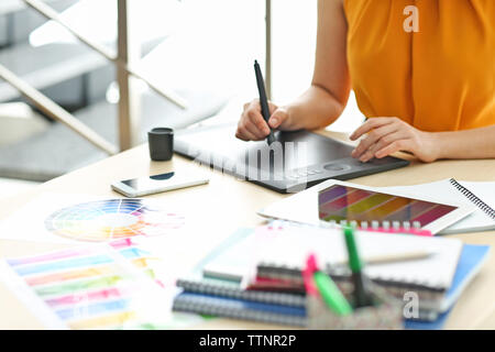 Designer workplace. Woman using tablet Stock Photo