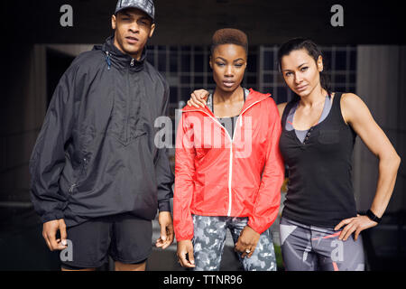Portrait of confident athletes standing together outdoors Stock Photo