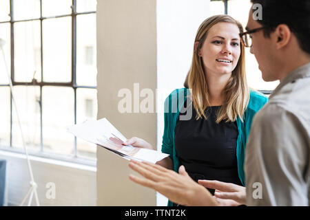 business people discussing over documents at office Stock Photo