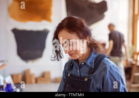Colleagues working in workshop Stock Photo