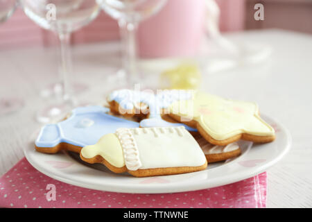 Baby glazed cookies on decorated table Stock Photo